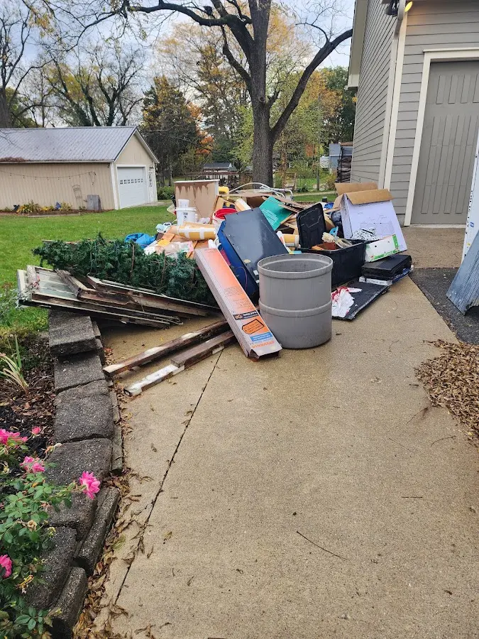 Dumpster being loaded with debris for Estate Cleanout Dumpster Rental in Denison